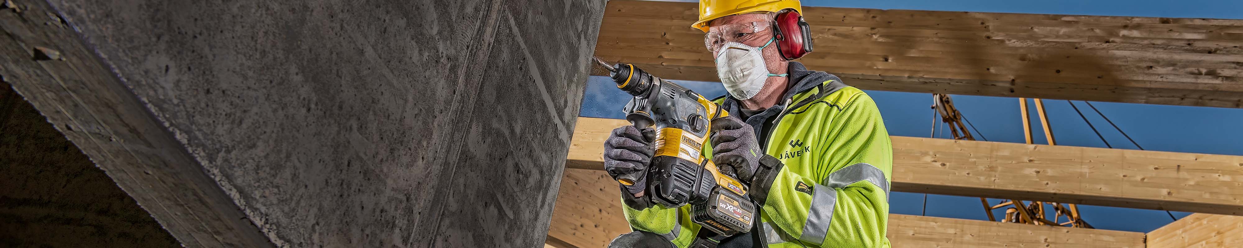 Construction worker using a drill on a site