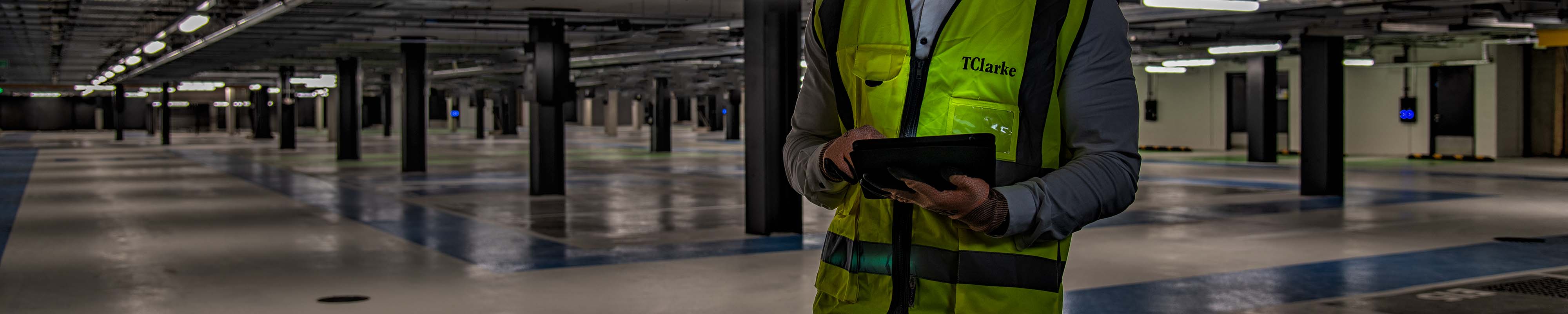 Manager using a tablet to contact a photographer on a construction site