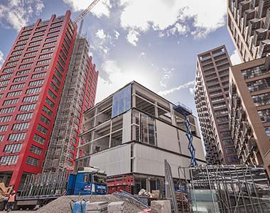 Cladding being fitted to a concrete frame building