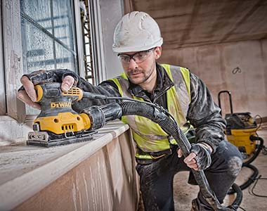 Worker using a dewalt sander