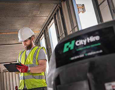 Site manager using an ipad to order hire equipment