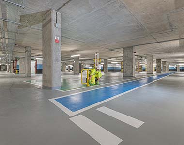 Painter marking out bays in a carpark