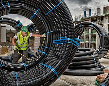 Worker measuring a large pipe