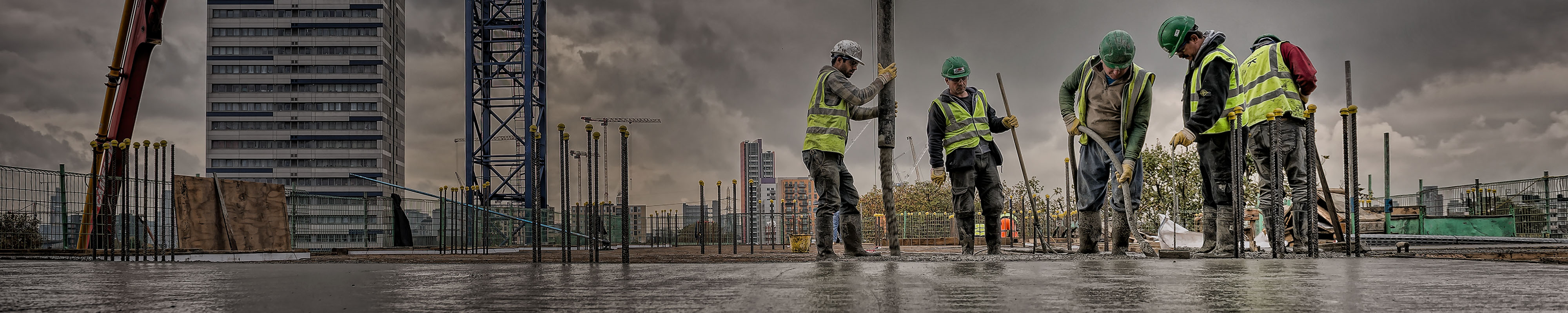 Group of workers on a site pouring concrete